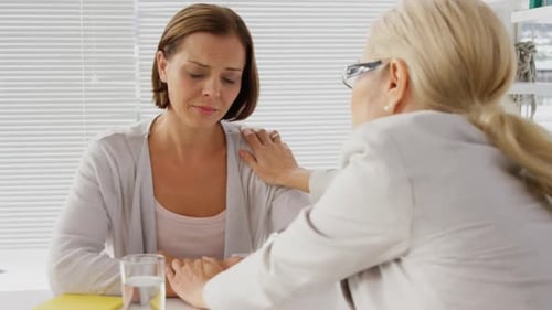 Woman Receiving Comfort at Office Table