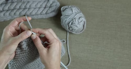 Hands Knitting Gray Wool Garment Close-Up
