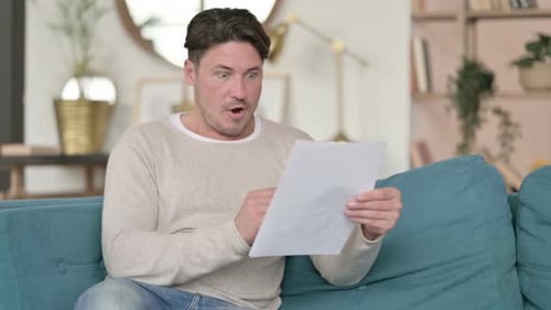 Man Celebrates Reading Good News at Home