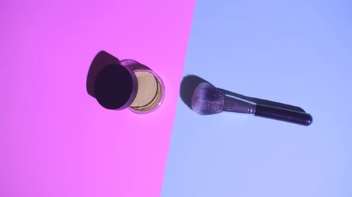 Makeup Powder and Brush on Pink and Blue