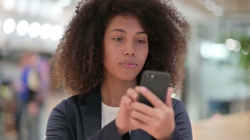 Adult Using Smartphone in a Modern Office