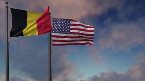 Belgium and United States Flags Waving Against Blue Sky