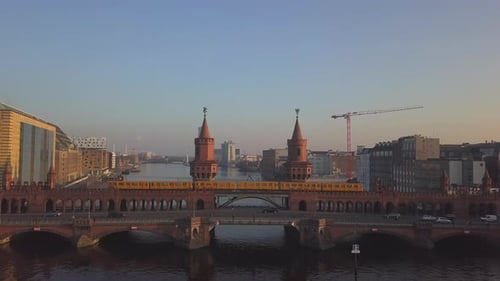 AERIAL: Berlin Yellow Subway Crossing Bridge, Oberbaumbruecke in Blue Sky Over Spree Close Up