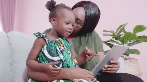 Mother and Daughter With Tablet on the Couch