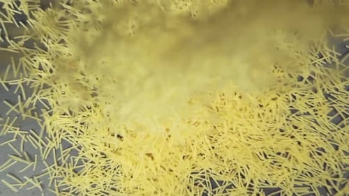 Dry Pasta Sprinkled Across a Gray Surface