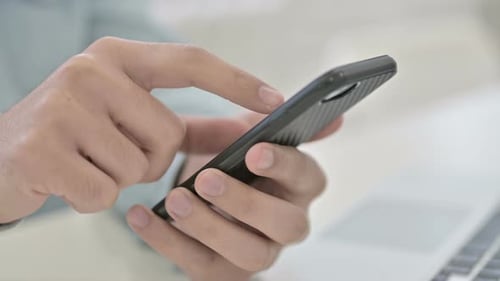 Close Up Of Hands Scrolling On Smartphone