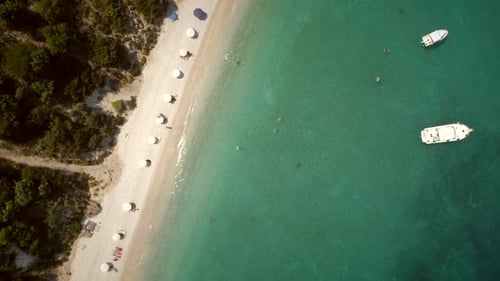 Aerial view of a paradise beach with turquoise water and white sand in Syros