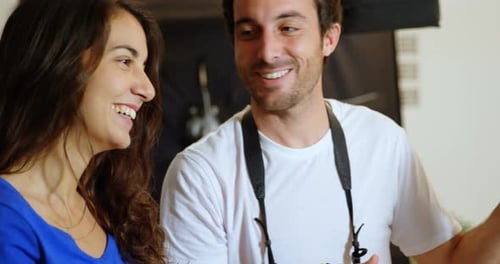 Smiling Man and Woman Talking Indoors