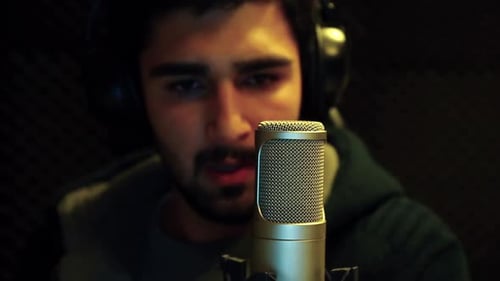 Man Recording Voiceover in Dark Professional Studio