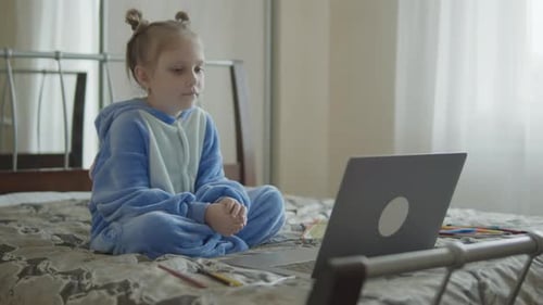 Girl Watching Laptop in Bedroom at Home