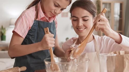 Woman and Child Cooking Together at Home