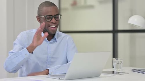 Man using laptop for video call in office