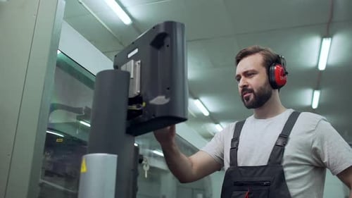 Man Working at Computer in Factory