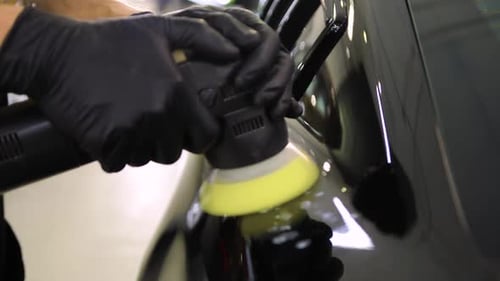 Automotive Detailer Polishing Car with Buffer