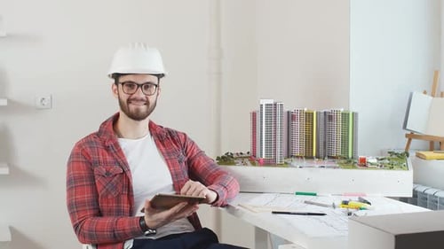Portrait of Smiling Young Architect in Office.