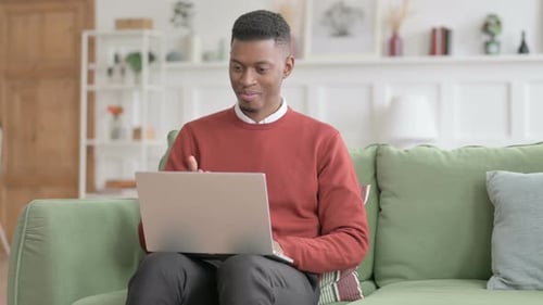 Young Adult Video Chatting on Laptop From Home