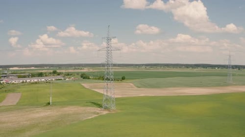 Aerial View of Electricity Pylon in Green Field