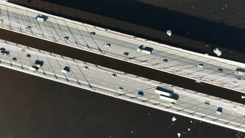 Aerial Shooting with Rotation Above the Cable-stayed Bridge Over the River, Cars Driving on the Road