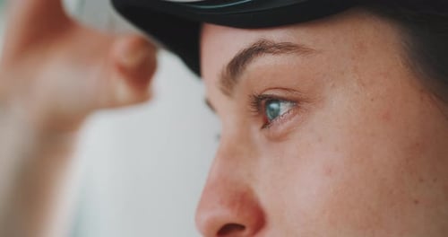Close up of eyes of young woman putting vr goggles on and off