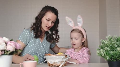 Woman and Child Decorating for Easter at Home