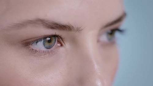 Close Up View of Attractive Young Woman Face Opening Eyes and Looking to Aside