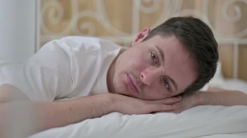 Close Up of Peaceful Young Man Sleeping in Bed