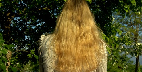 Woman with Long Blonde Hair Tossing Her Hair