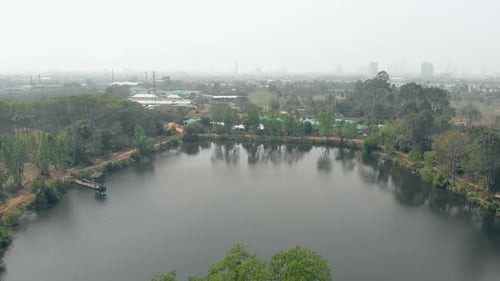 Upper View Lake Surrounded By Trees Reflecting in Water