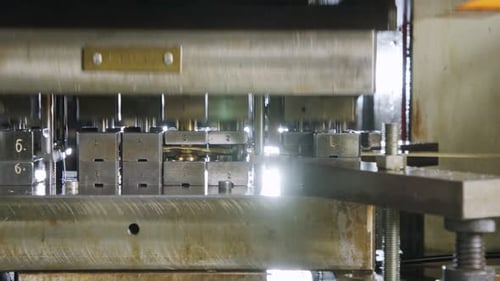 A large industrial punch press forming high precision metal parts for the automotive industry