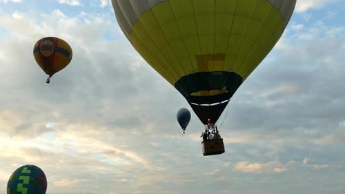 Flight of balloons in the morning sky