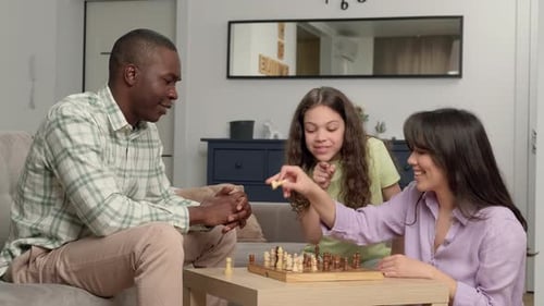 Family Enjoying a Game of Chess Together
