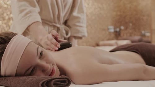 Young Woman Having Hot Stones Therapy
