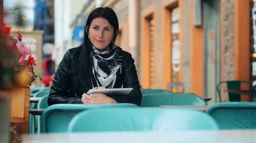 Young Woman Using Digital Tablet at Street Cafe