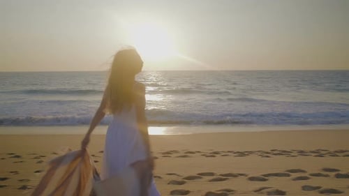 Happy Young Couple Hugging on Beach
