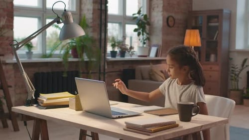 Girl Studying with Laptop at Home Desk