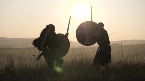 Silhouetted Warriors in Sword Fight at Sunset