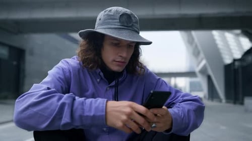 Young Adult Using Smartphone in Urban Setting