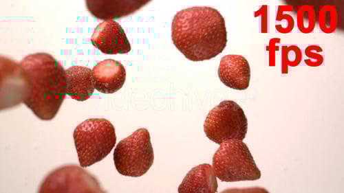 Juicy Strawberries Falling in Bowl of Cream