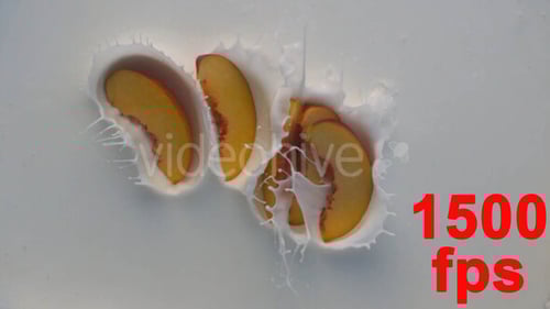 Peach Slices Splashing into White Creamy Liquid