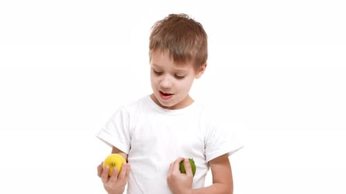 Boy with Lemon and Lime Offers Fruit to Camera