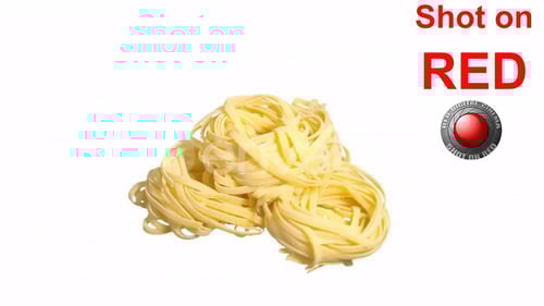 Uncooked Tagliatelle Nests on a White Background
