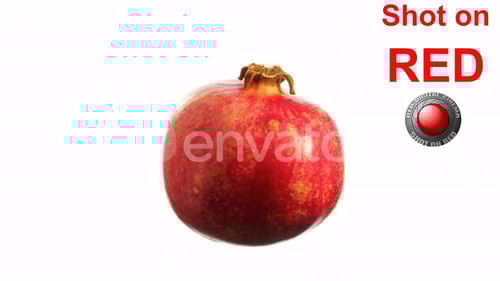 Ripe Pomegranate Slowly Spinning on White Background