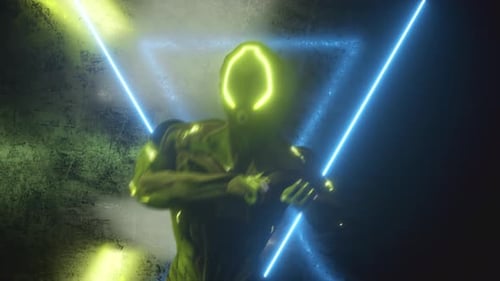 Futuristic Glowing Figure Posing Amidst Neon Light Triangles Loop