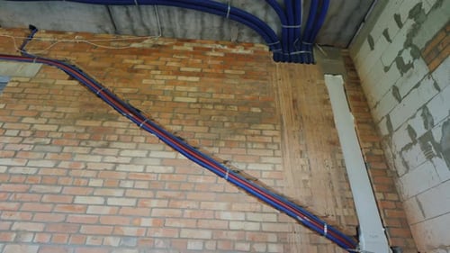 Interior Construction with Plumbing Pipes and Bare Walls