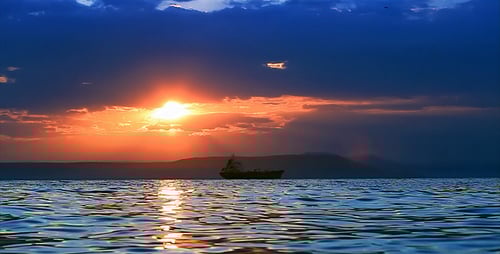 Cargo Ship at Sea During Golden Sunset