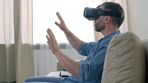 Man Wearing VR Headset on Couch