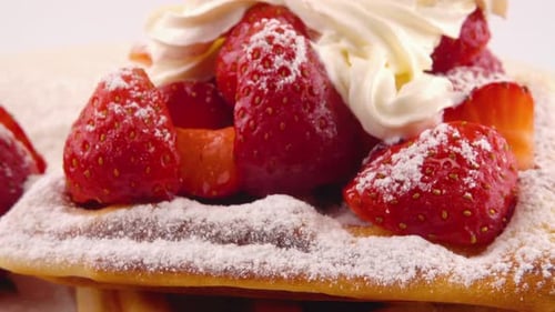 Delicious Waffles Topped with Strawberries and Cream