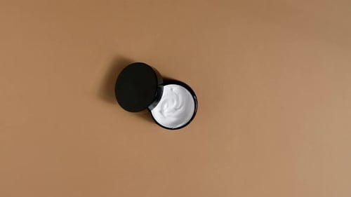 Black Jar of White Cream, Flat Lay