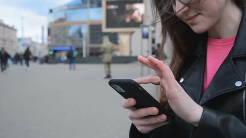 A Girl Writes a Message on the Street