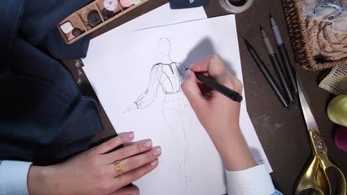Designer Creating Fashion Sketch on Paper